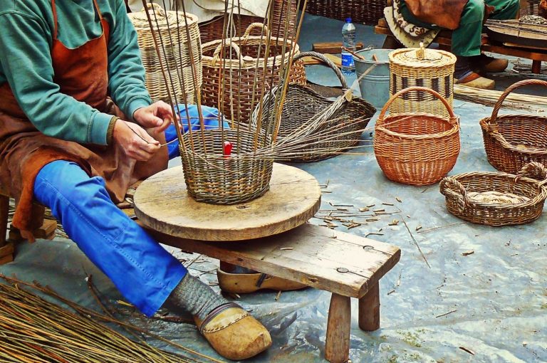 A person out of frame hand making a basket